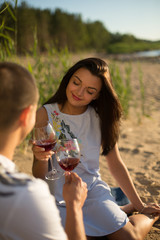 A young couple in love, on the shore of the Bay at sunset