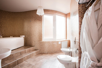 Modern luxury bathroom with bathtub and window. Interior design.