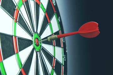 Right on target concept using dart in the bullseye on dartboard