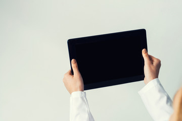 Close of female doctor hands working with tablet pc computer