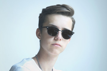 Young man serious portrait in sunglasses