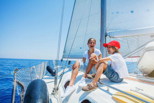 Brother And Sister On Board Of Sailing Yacht On Summer Cruise. Travel Adventure, Yachting With Child On Family Vacation.