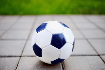 Fototapeta na wymiar Traditional soccer ball on the walkway in par