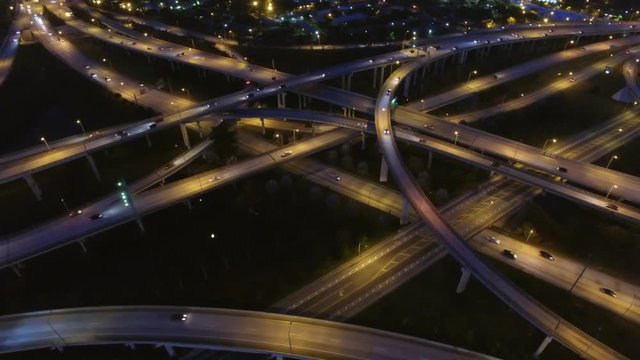 Aerial view of urban highway system at night.