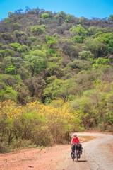 Obraz premium Woman cycling on the corrugated road in Argentina