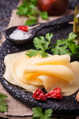Cheese slices on cast iron board