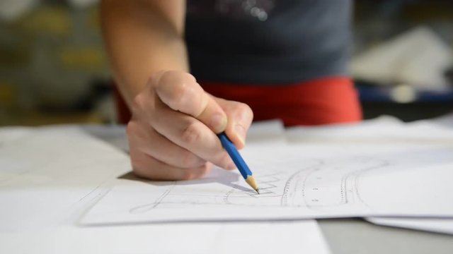 Designer shoes creates a sketch on the paper