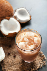 Obraz na płótnie Canvas Glass of cold tasty coconut coffee on table