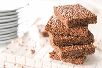 Delicious chocolate rice crispy treats on wooden board