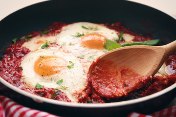 Frying pan with eggs in purgatory, close up