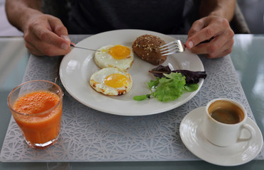 Healthy eating and lifestyle concept. Young man enjoying his breakfast close up.