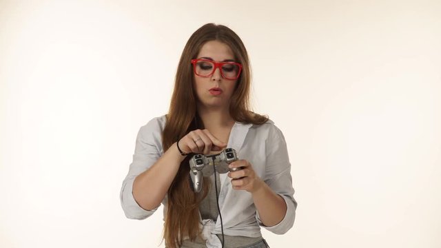 Funny girl holding controller console. Young cute female with pad joystick playing games. 4K ProRes HQ codec