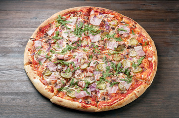 Delicious pizza with ham and arugula. Top view