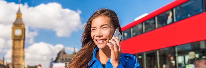 Poster London tourist Asian woman talking on phone banner. Urban businesswoman calling cellphone, red bus and Big Ben, Parliament urban background. Europe destination, England, Great Britain. © Maridav