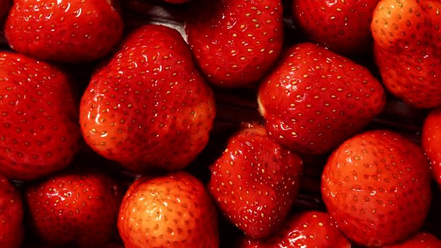 Fresh strawberry fruits as food background. Healthy food organic nutrition. View from above. Dolly slider shot 4K ProRes HQ codec