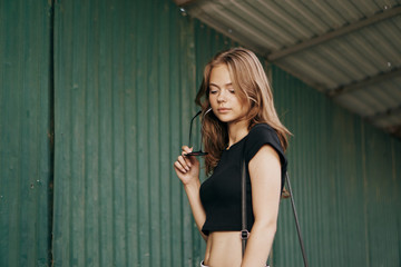 Fototapeta premium Beautiful young woman walking outdoors in city in summer