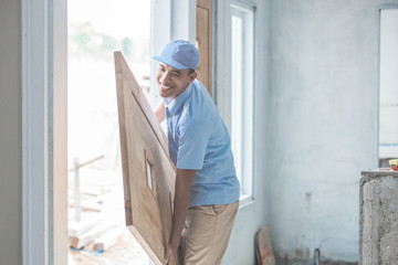 Fototapeta premium Worker installing doors