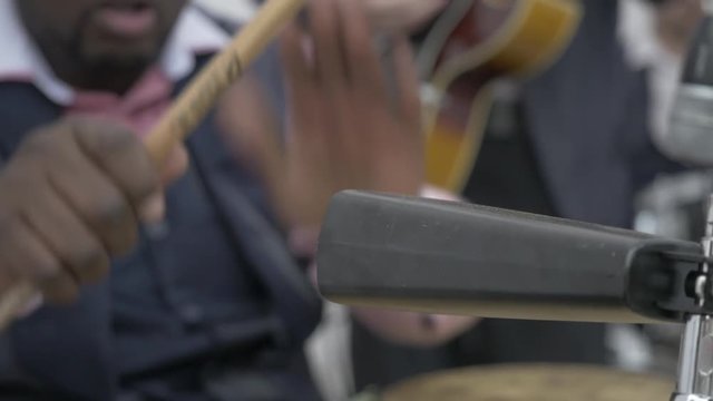Hands drumming. Drummer playing on drum set on stage. Drummer pounding drums, musicians hand close up. Street musician playing drums