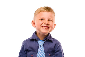 Positively Teeth Smiling Baby Boss. Blond hair and bright eyes. Dressed in dark blue shirt with striped tie. Isolated background.