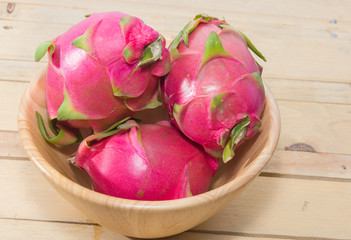 dragon fruit on wooden bowl