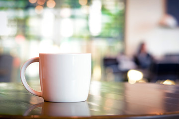 Coffee cup on wooden table in coffee shop