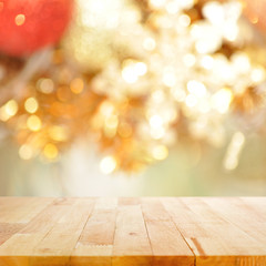 Naklejka na ściany i meble Wood table top on blurry gold background - festive background concept