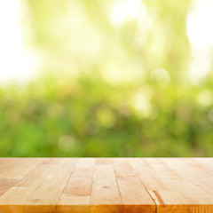 Wood table top on blurry green abstract background