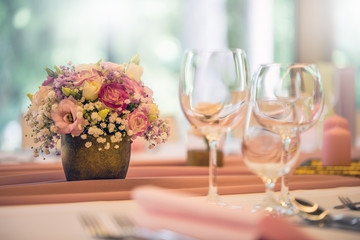 Wedding table setting. Beautiful table set with flowers and glass cups  for some festive event, party or wedding reception