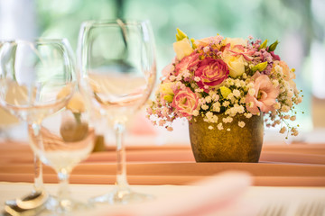 Wedding table setting. Beautiful table set with flowers and glass cups  for some festive event, party or wedding reception