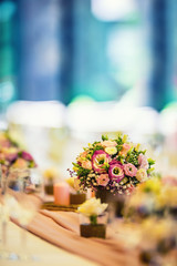 Wedding table setting. Beautiful table set with flowers and glass cups  for some festive event, party or wedding reception