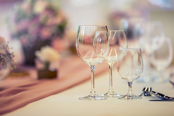 Wedding table setting. Beautiful table set with flowers and glass cups  for some festive event, party or wedding reception