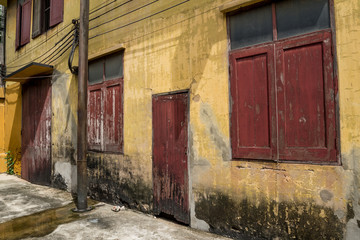 Old wall of vintage warehouse with red wooden windows