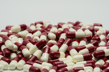 Two tone antibiotic capsule pills on white background, drug resistance