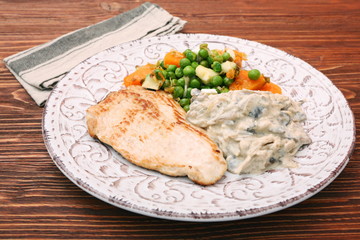 Turkey fillet with mushrooms in cream sauce and vegetables
