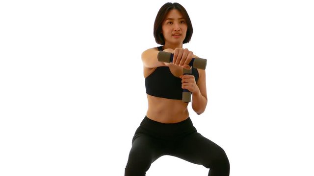 Pretty Thai Asian sportswoman is doing dumbbell punch in both hands posture. Weight exercise cardio workout in white isolated background in fitness concept 