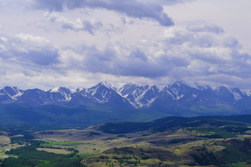 View of white peaks of North-Chuyski ridge and Kurai steppe in Altai mountains. Altay Republic, Siberia, Russia.