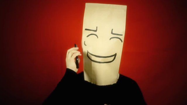 A stop sign appears over a shy bashful breadbag face, in a conversation on a smartphone.
