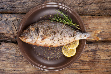 Seafood eating. Grilled fish on plate from above.