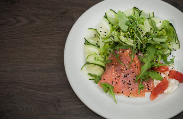 Meat of trout on a plate with vegetables and grapefruit