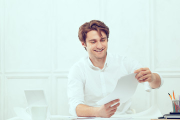 Businessman using laptop with tablet and pen