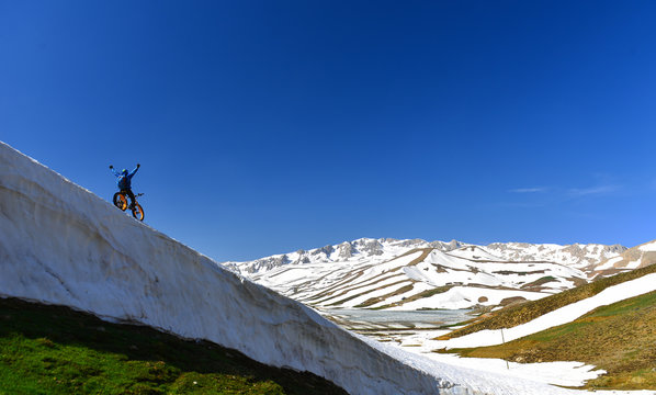 Adventure in high and snowy mountains with bike