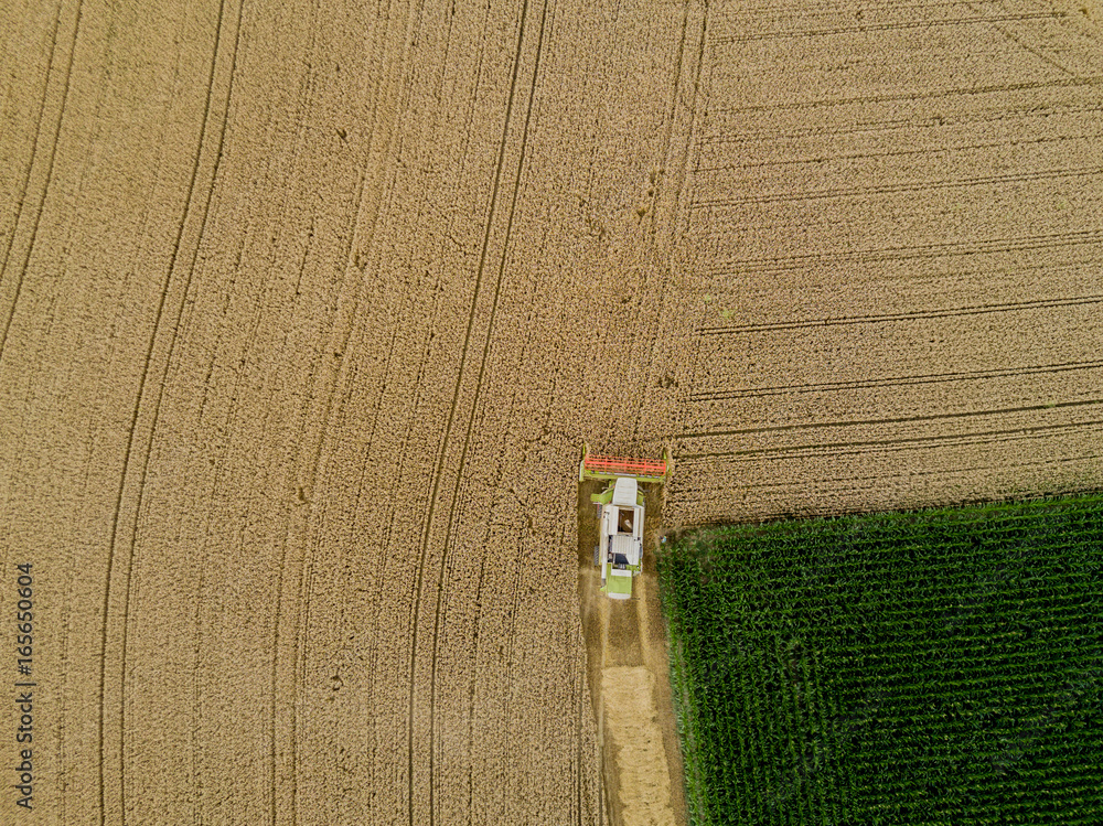 Sticker Aerial view of combine harvester  on a field