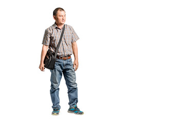 Portrait of a happy mature man standing in scott shirt and blue jeans looking to the right side. Isolated full length on white background with copy space and clipping path