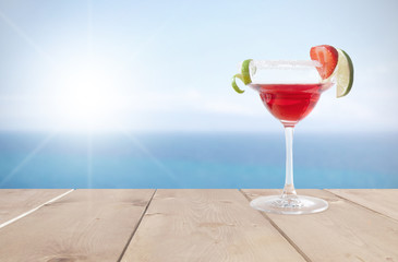 Red cocktail by the sea