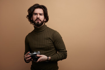 Stylish bearded man with photo camera