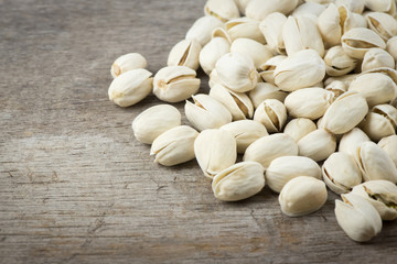 pile pistachios on a wooden table,Selective focus.