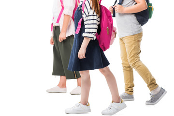 cropped shot of children with backpacks walking together isolated on white