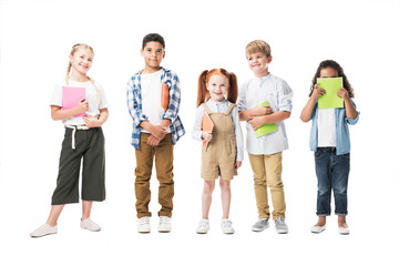 adorable multiethnic children holding textbooks and smiling at camera isolated on white