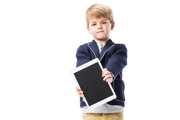 Obraz premium cute little boy holding digital tablet with blank screen and looking at camera isolated on white