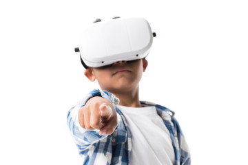 african american boy wearing virtual reality headset and pointing at camera isolated on white